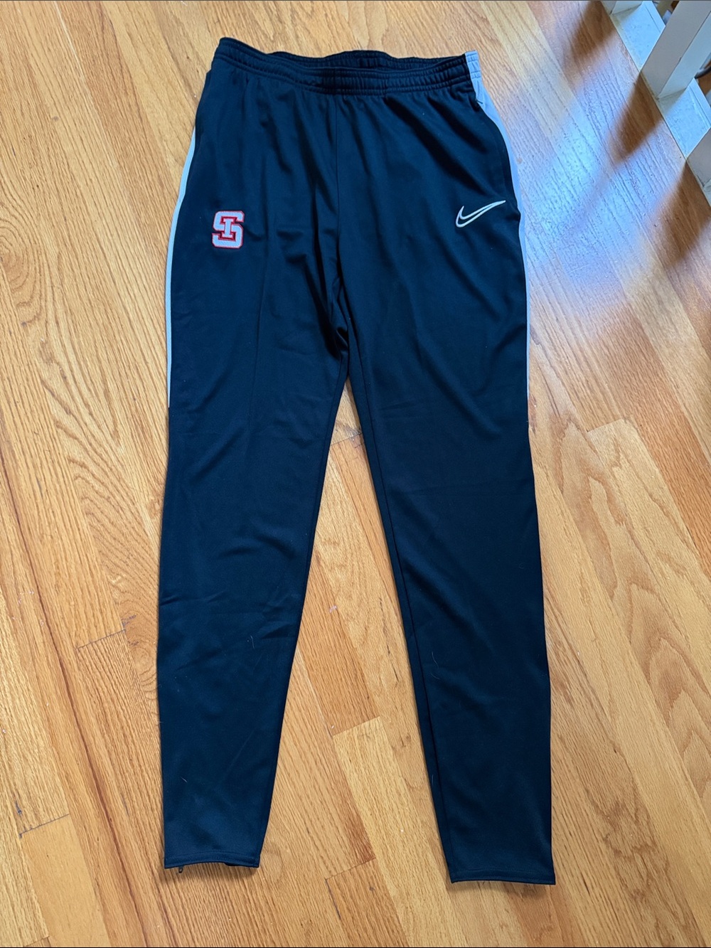 Nike Black Track Pants with White Side Stripe and Red Crest